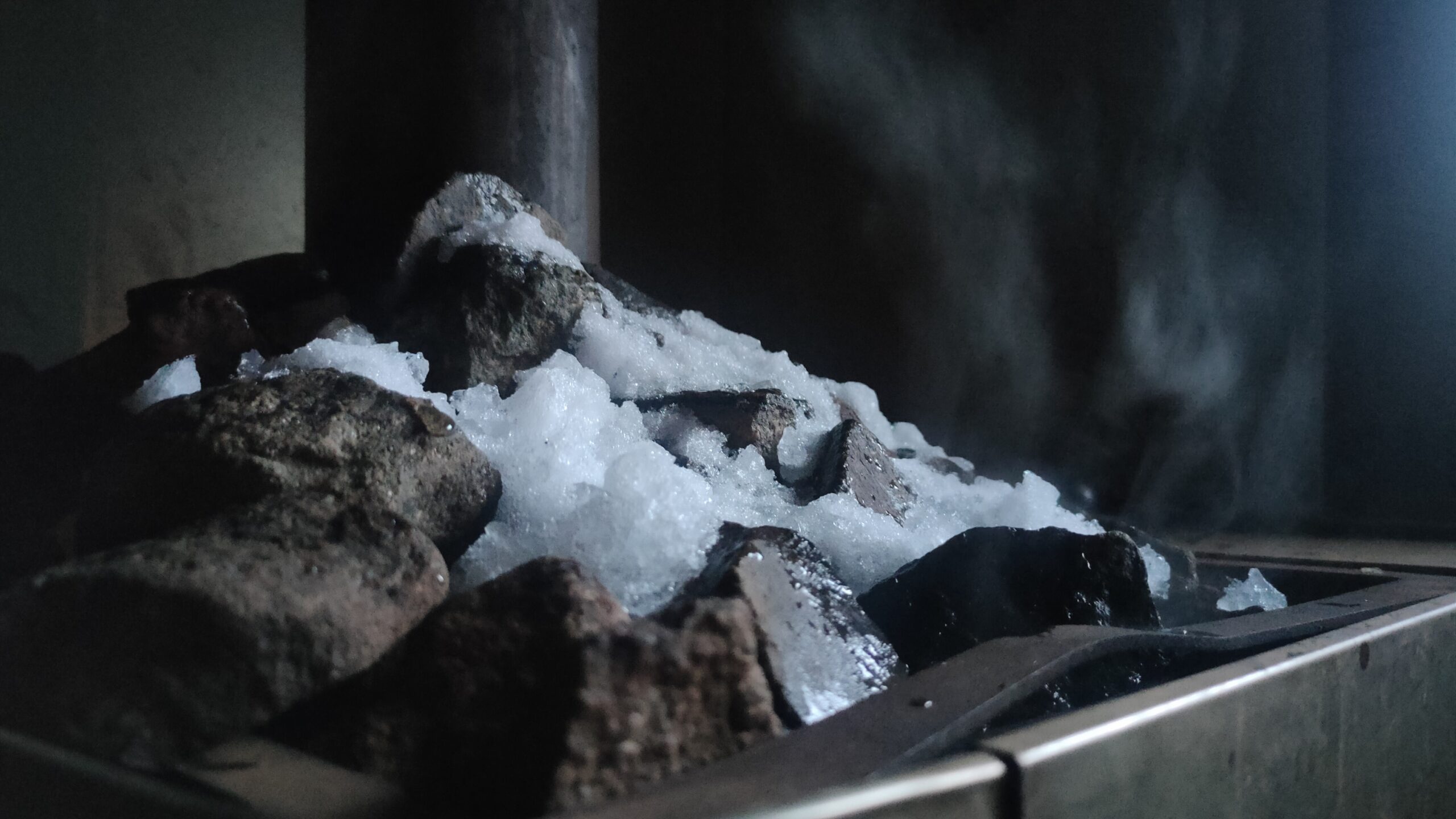 Hot sauna stones with rising steam